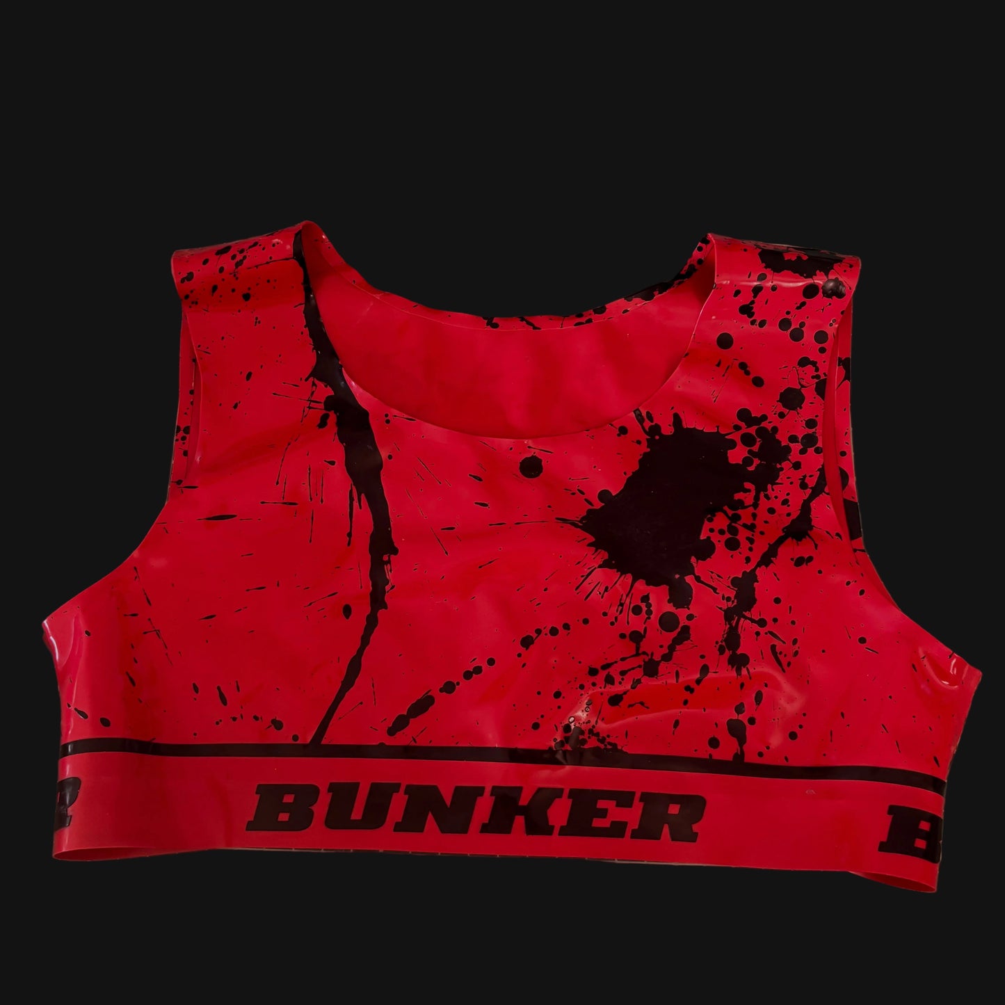 Red crop top with black splatter design and 'Bunker' branding on a grid surface.